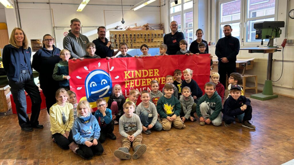 Die Kinder der Kinderfeuerwehr Lünen präsentieren gemeinsam mit den Betreuern der Feuerwehr Lünen den selbstgebauten Setzkasten.